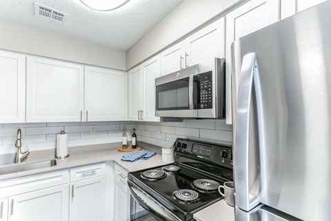 a kitchen with stainless steel appliances and a microwave