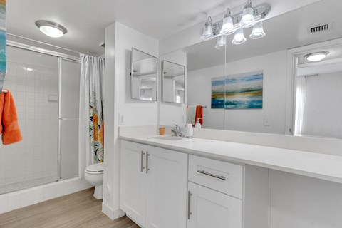 A bathroom with a white counter and a white sink at Boca Colony Apartments, Boca Raton, FL, 33433