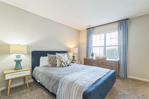 a bedroom with a bed and a window at Magnolia Terrace Apartments, Charlotte