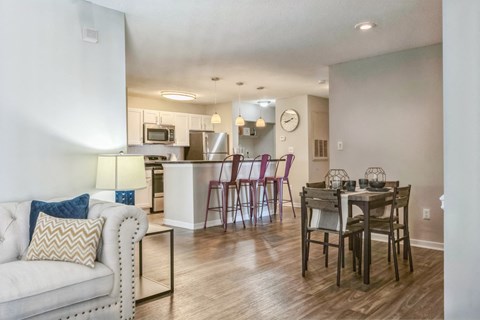 an open living room and kitchen with a dining room table and chairs