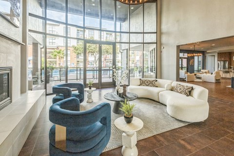 A living room with a blue chair and a white couch.
