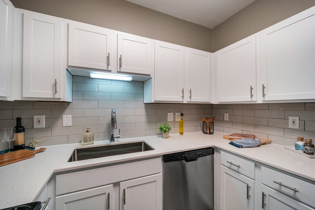 a kitchen with white cabinets and a sink