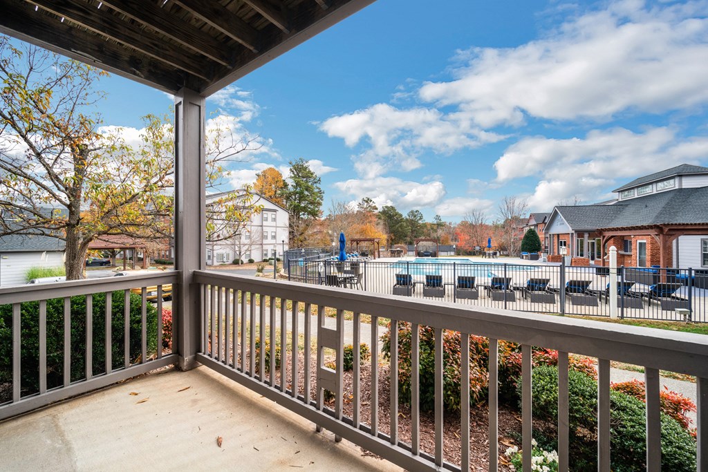 the view of the pool from the balcony of a house with a pool