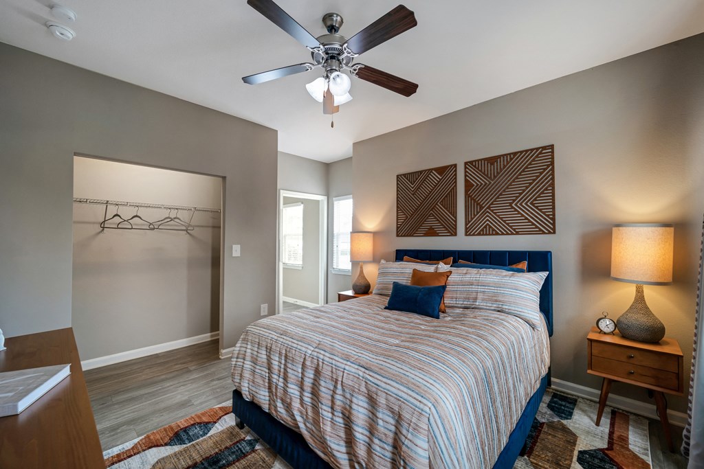 a bedroom with a bed and a ceiling fan