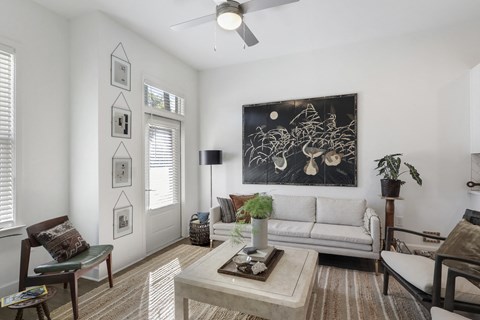 Living room with a white couch at Arcadia Decatur, Decatur, GA.