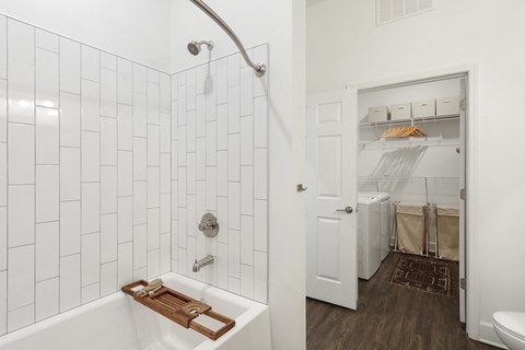 White bathroom with a shower and a tub combo at Arcadia Decatur, Decatur, Georgia.