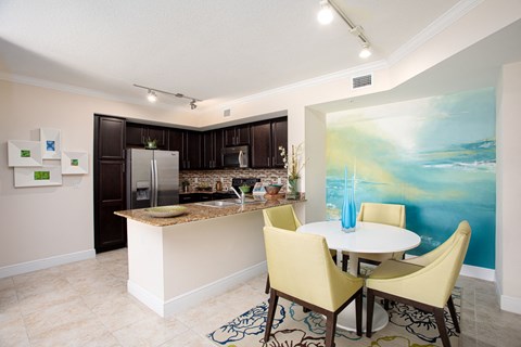 a kitchen and dining room with a table and chairs