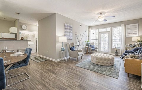 A living room with a dining table and chairs.