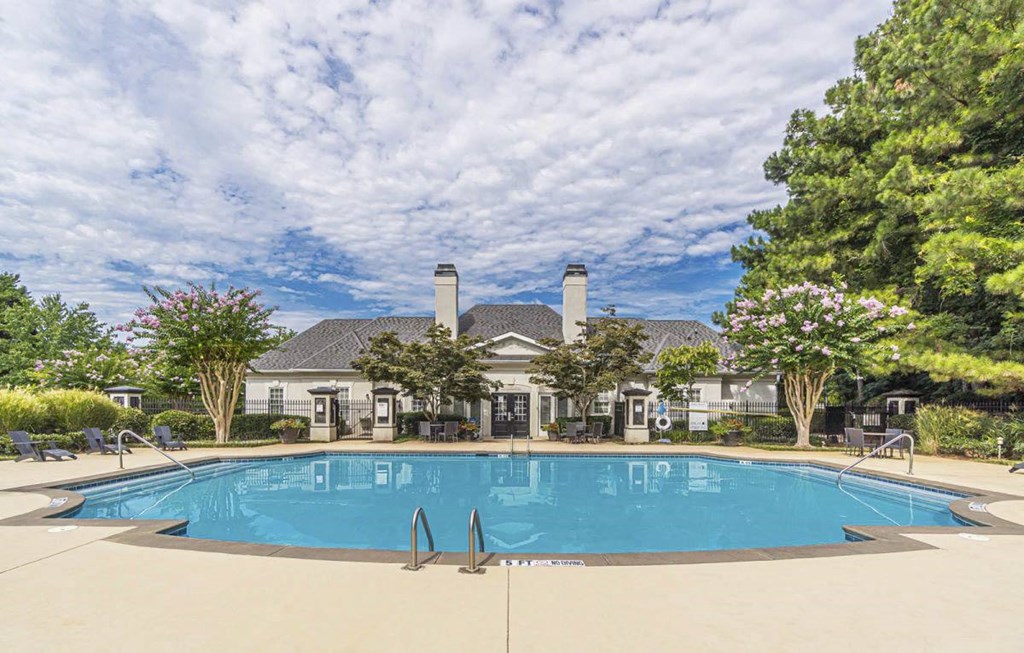 A large swimming pool in front of a house with a pool house.at The Atlantic Canton Ridge, Canton, GA 30114