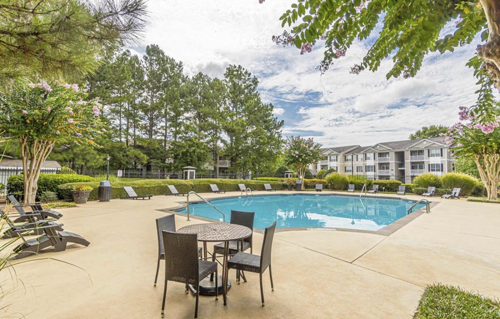A pool area with chairs and a table.at The Atlantic Canton Ridge, Canton, 30114