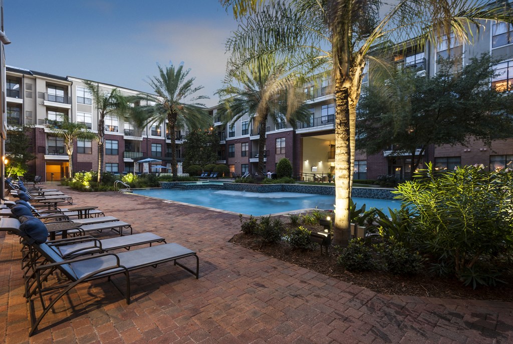 Resort-Inspired Pool with Sun Ledge, Lap Pool, and Waterfall.