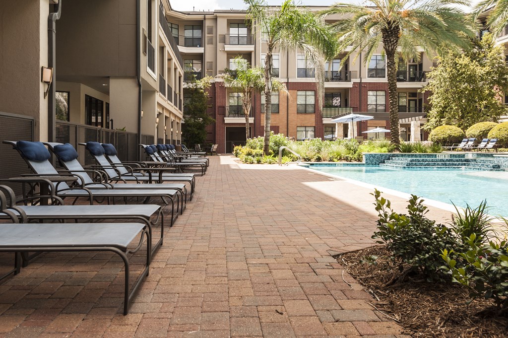 Resort-Inspired Pool with Sun Ledge, Lap Pool, and Waterfall.