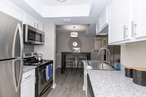 a kitchen with stainless steel appliances and granite counter tops