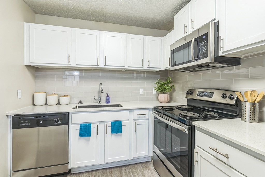 A kitchen with white cabinets at The Atlantic Loring Heights, Atlanta, Georgia
