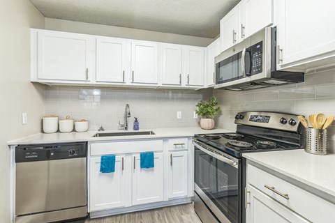 A kitchen with white cabinets at The Atlantic Loring Heights, Atlanta, Georgia