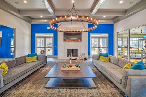 a living room with couches and a coffee table and a fireplace