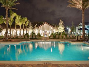 Swimming pool at night in front of a house at The Atlantic at Tradition, Port St Lucie