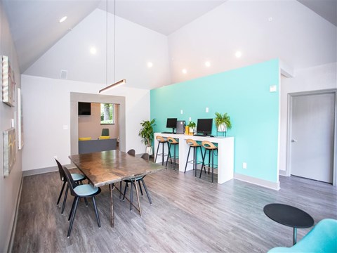 a dining room and kitchen with a table and chairs
