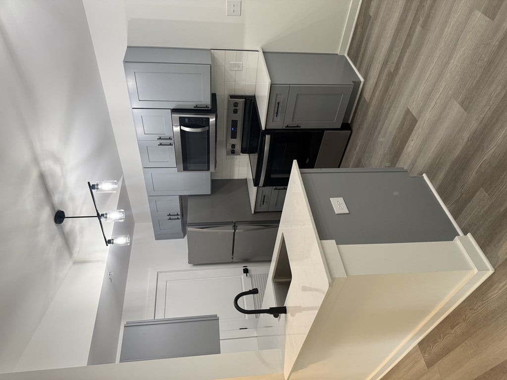 A modern kitchen with a staircase leading to the upper floor at The Atlantic Brookhaven, Georgia, 30329