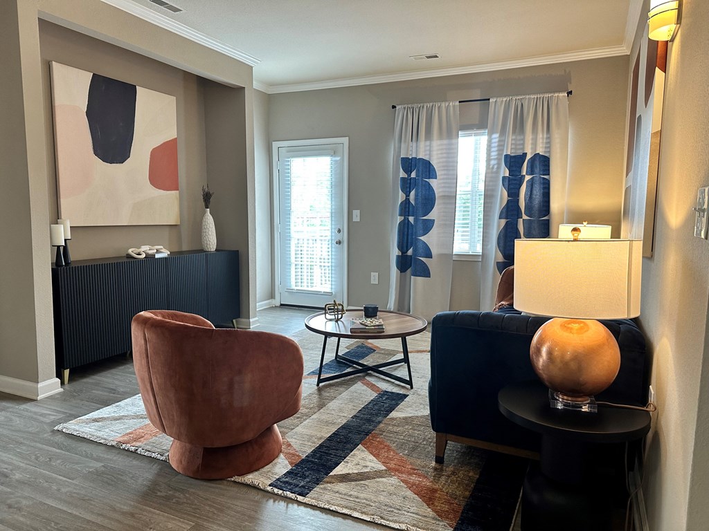 a living room with a couch and two chairs