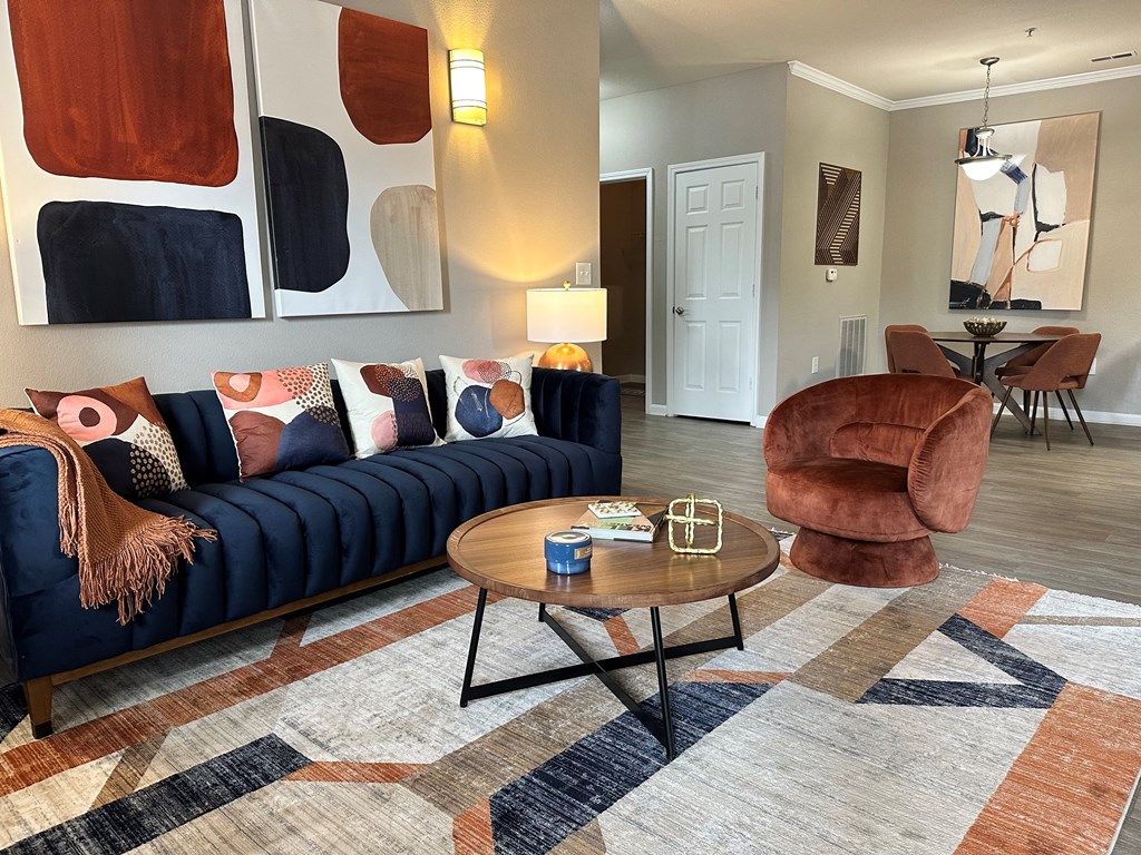 a living room with a blue couch and a brown chair