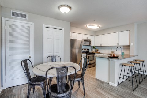 a kitchen and dining room with a table and chairs