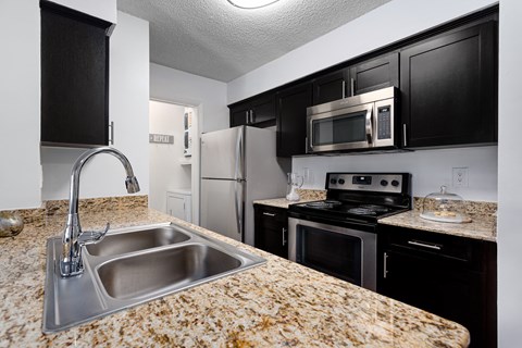 a kitchen with stainless steel appliances and granite counter tops
