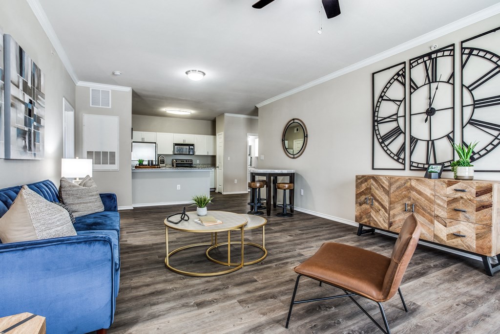 a living room with a large clock on the wall and a couch at Village of Hawks Creek Apartments, Westworth Village, 76114