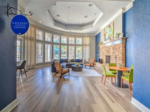 a living room with a fireplace and a table with chairs