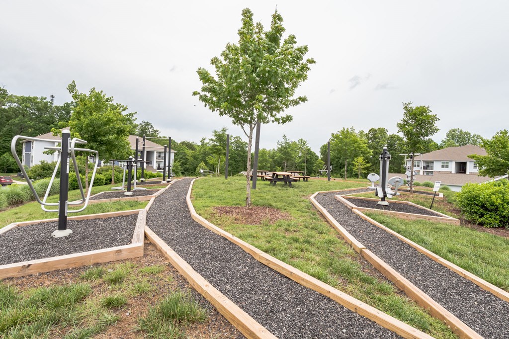 Path through a park with trees and benches at The Atlantic Mountain Island, Charlotte, North Carolina