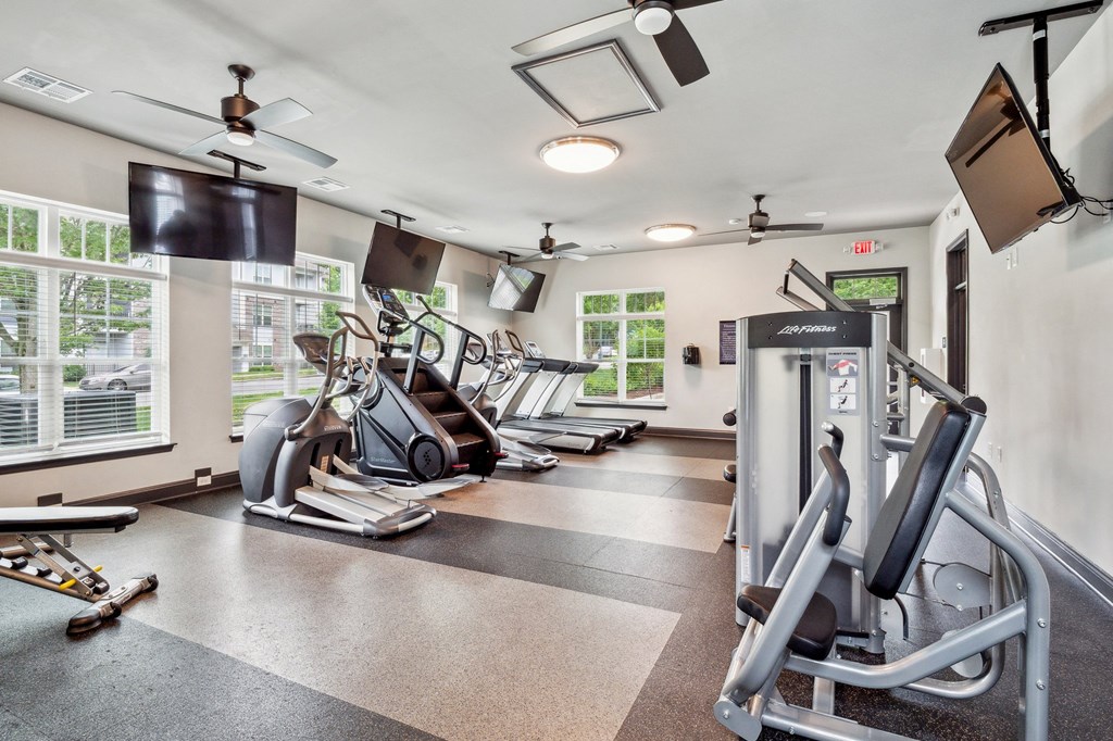 Gym with cardio machines and a tv on the wall at The Atlantic Mountain Island, North Carolina, 28216