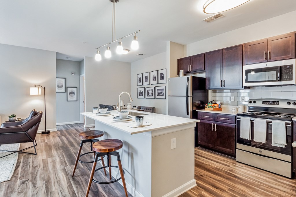 Open kitchen and living room with a large island with stools at The Atlantic Mountain Island, North Carolina