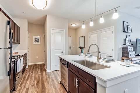 an open kitchen with a large counter top and a sink