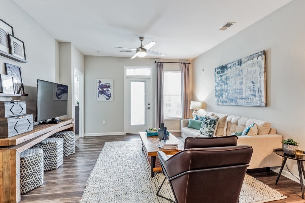 Living room with a couch and a tv at The Atlantic Mountain Island, Charlotte, North Carolina