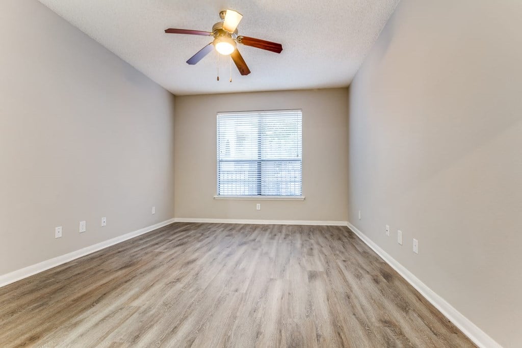 A room with a ceiling fan and a window with blinds. at Montecito Apartments, Houston, 77056