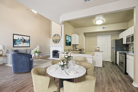 A modern living room with a dining table set for two.