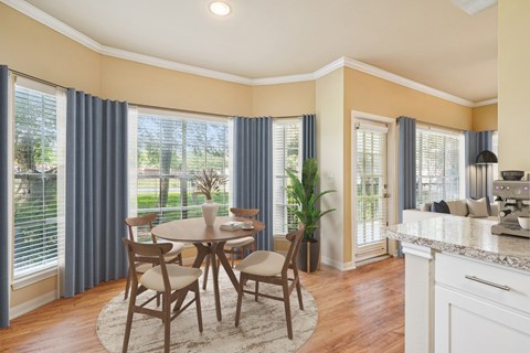 A kitchen with a table and chairs in the middle of the room.