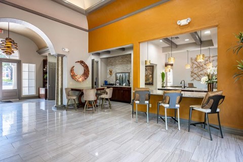 A kitchen with a dining table and chairs.