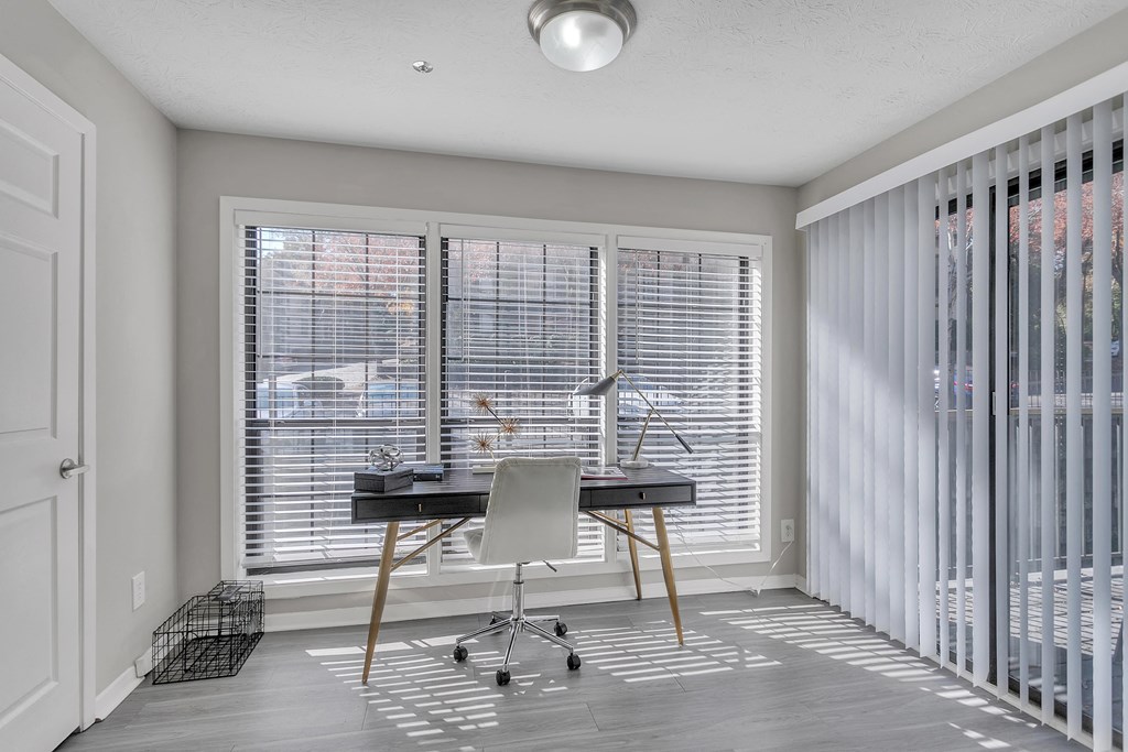Home office with blinds on the windows and a desk with a chair at The Atlantic Briarcliff, Atlanta, Georgia