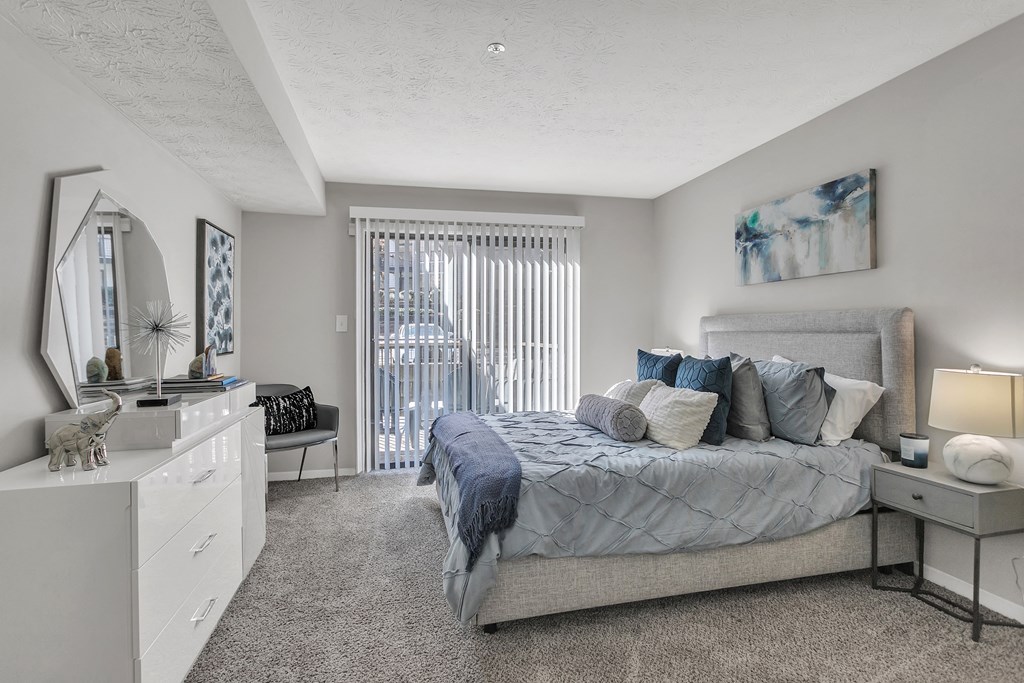 Bedroom with a bed and a dresser and a window at The Atlantic Briarcliff, Atlanta, GA, 30329