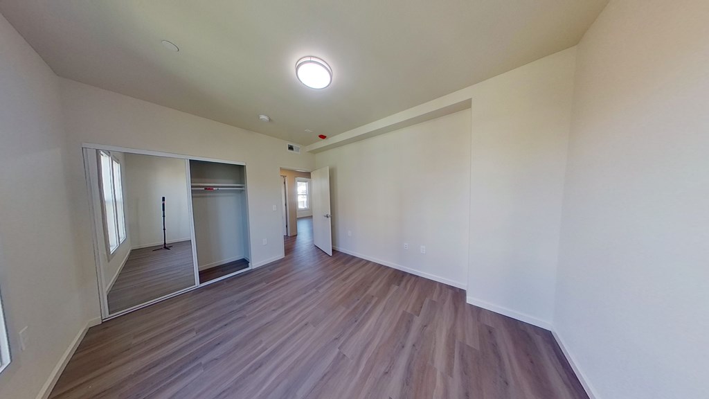 A room with wooden floors and white walls.