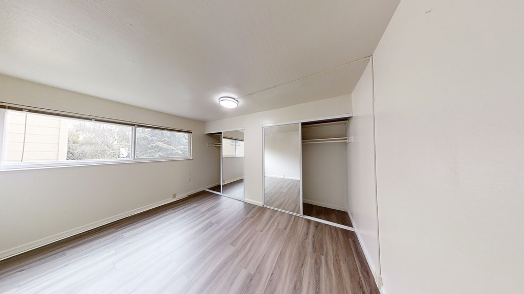 A room with wooden floors and white walls.
