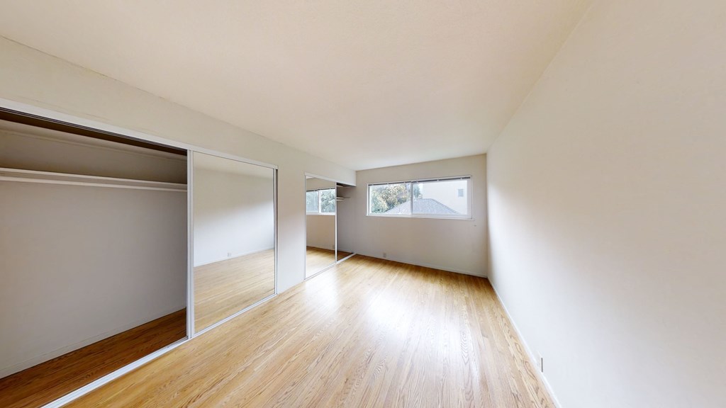 A room with wooden floors and white walls.