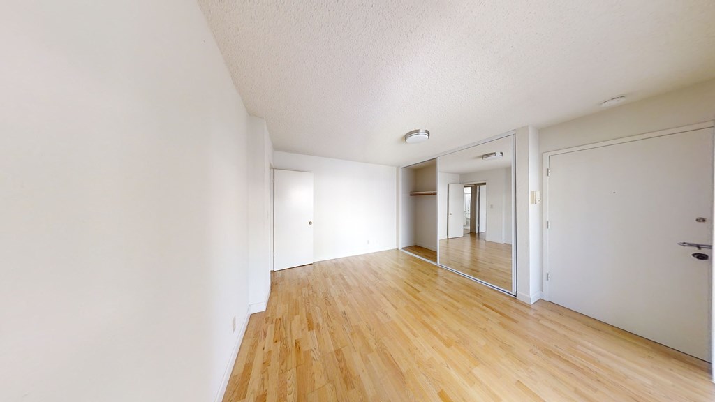 A room with wooden floors and white walls.