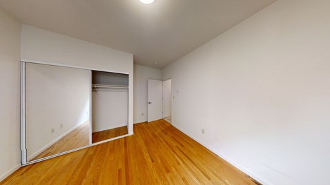 A room with wooden floors and white walls.