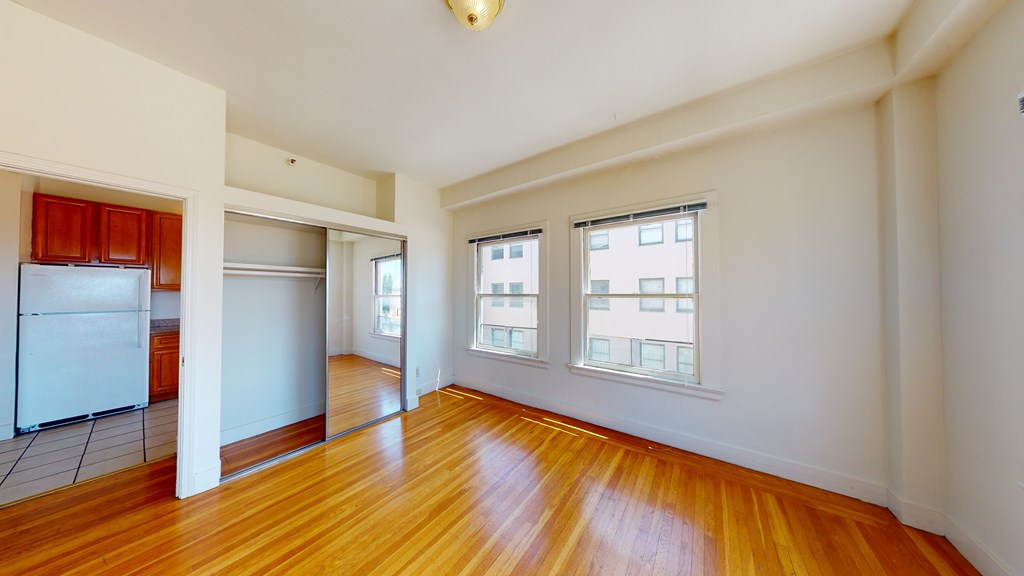 A room with wooden floors and white walls.