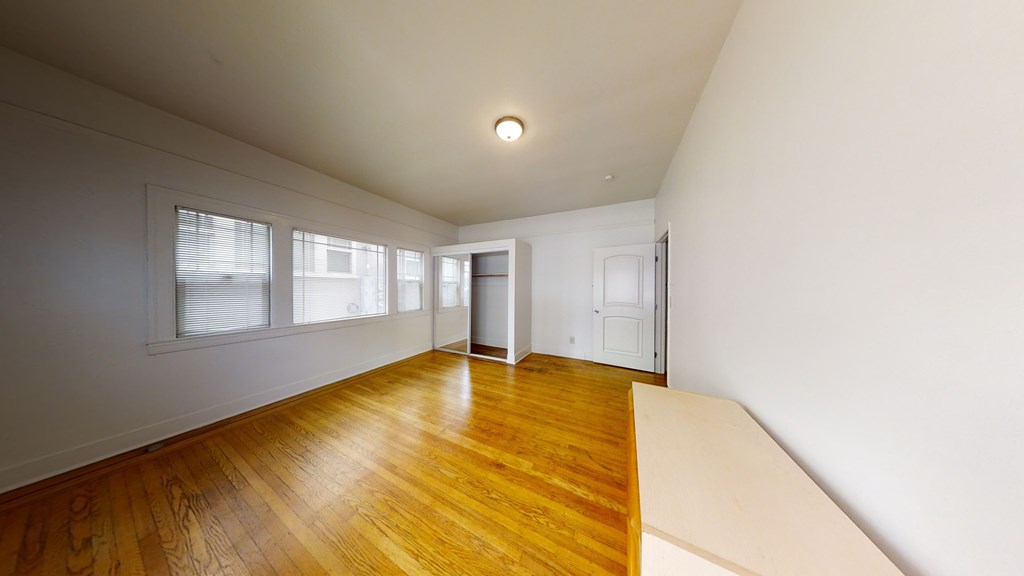 A room with wooden floors and white walls.