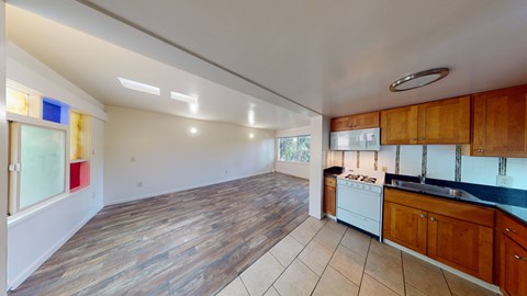 A kitchen with wooden cabinets and a white dishwasher.