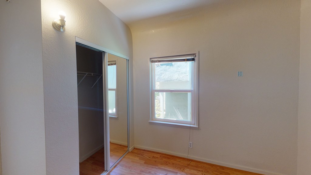 A room with a sliding glass door and a window.