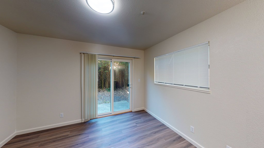 A room with a sliding glass door leading to a snowy landscape.